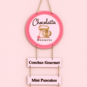May include: A pink and gold sign for a dessert shop, "Chocolatta Desserts," with a mixer graphic. Below, rectangular signs list "Conchas Gourmet," "Mini Pancakes," "Sean to pay," and "Connect with us."