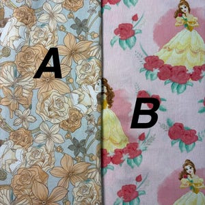 May include: Two fabric swatches. One features a floral pattern in shades of tan and white on a light blue background. The other has a pink background with a repeating pattern of a princess in a yellow gown and red roses. The letter "A" and "B" are printed on the fabrics.