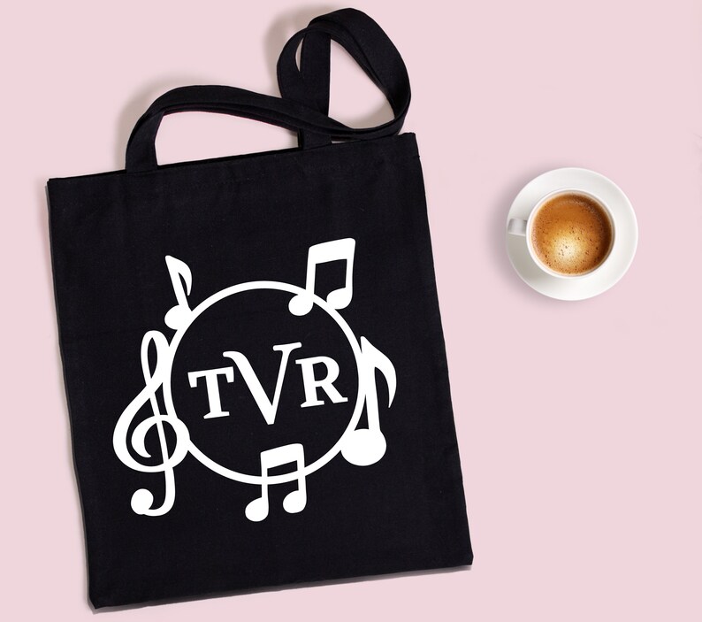 May include: Black tote bag with white musical notes and a circle containing the letters "TVR".