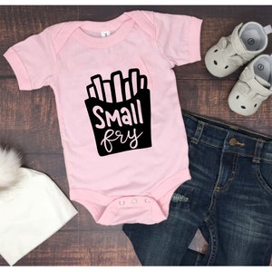 May include: Pink baby onesie with a black graphic of french fries and the text "Small fry".