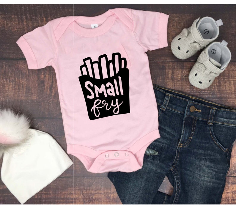 May include: Pink baby onesie with a black graphic of french fries and the text "Small fry".
