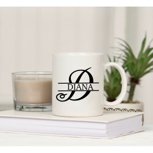 May include: White ceramic mug with a black cursive letter D and the name "DIANA" printed on it.