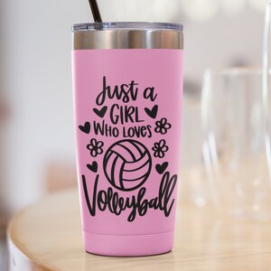 May include: Pink stainless steel tumbler with a black straw and a black vinyl decal that reads "Just a girl who loves volleyball" with a volleyball graphic and hearts and flowers.