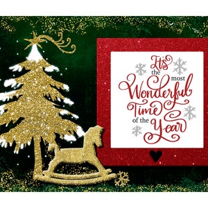 May include: A red glitter frame with a white background and the text "It's the most Wonderful Time of the Year" in a red and grey script font. The frame is surrounded by a green glitter background with a gold glitter Christmas tree and a rocking horse.
