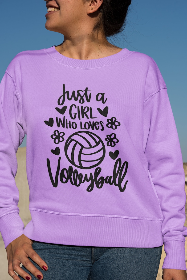 May include: Purple sweatshirt with the text "Just a girl who loves volleyball" in black lettering with a volleyball graphic.