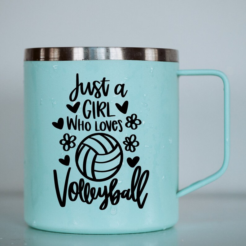 May include: A light blue stainless steel travel mug with a black vinyl decal that reads "Just a girl who loves volleyball" with a volleyball graphic and hearts and flowers.