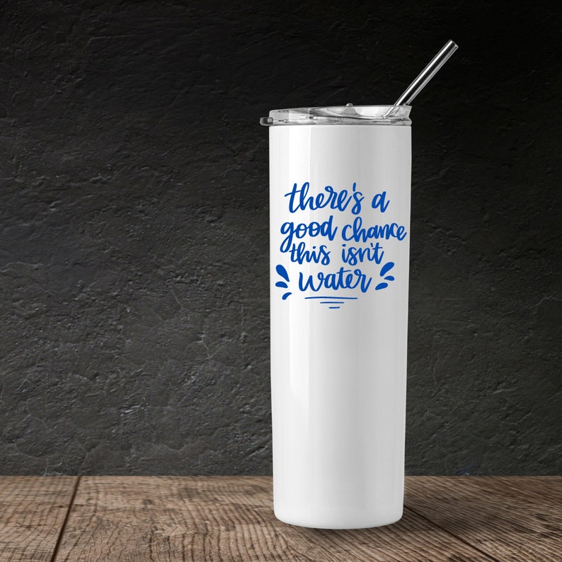 May include: White stainless steel tumbler with a blue inscription that reads "there's a good chance this isn't water".