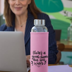 May include: Pink insulated water bottle with a black graphic that says "there's a good chance this isn't water".