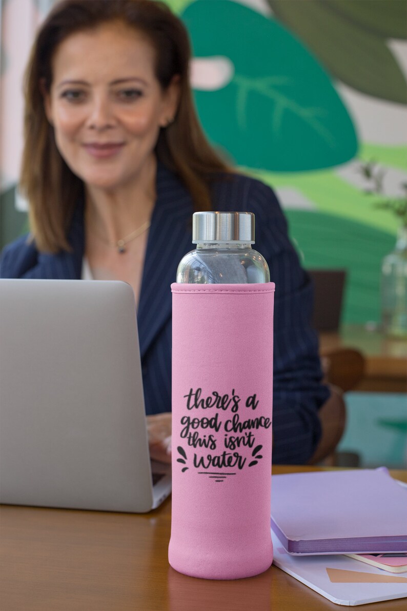 May include: Pink insulated water bottle with a black graphic that says "there's a good chance this isn't water".