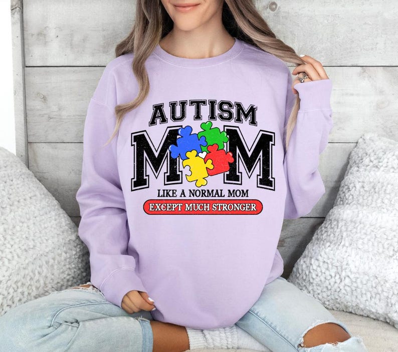 May include: Purple sweatshirt with the text "Autism Mom Like a Normal Mom Except Much Stronger" and a puzzle piece design.
