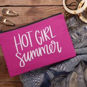 May include: A hot pink zippered pouch with the text "HOT GIRL SUMMER" in white lettering.