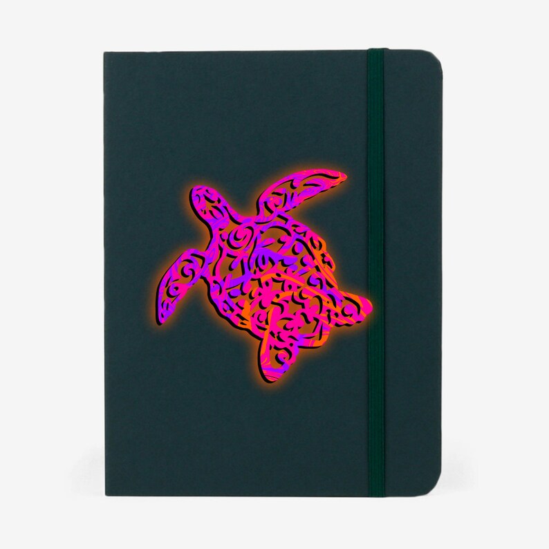 K&ouml;nnte beinhalten: Ein dunkelgr&uuml;nes Notizbuch mit einem pinkfarbenen und orangefarbenen Muster einer Meeresschildkr&ouml;te auf dem Einband.