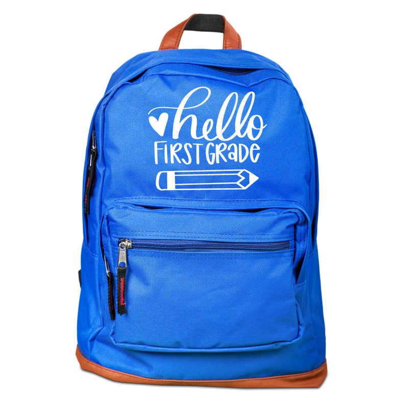May include: A blue backpack with a brown trim and a white design that says "hello first grade" with a heart and a pencil.