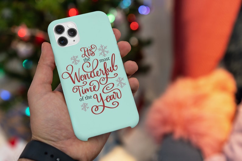 May include: A light blue phone case with a white snowflake design and the text "It's the most Wonderful Time of the Year" in red.