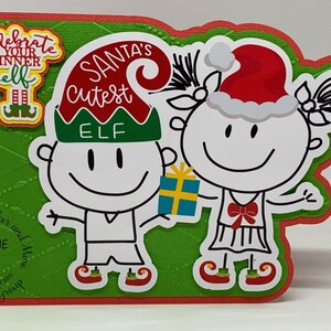 May include: A handmade Christmas card featuring two stick-figure elves. One elf is holding a gift. The card has the text "Santa's Cutest Elf" and "Celebrate Your Inner Elf". The card is green and red.