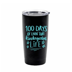 May include: Black stainless steel tumbler with a blue inscription that reads "100 Days of Livin' That Kindergarten Life" with stars on either side of the word "Life".