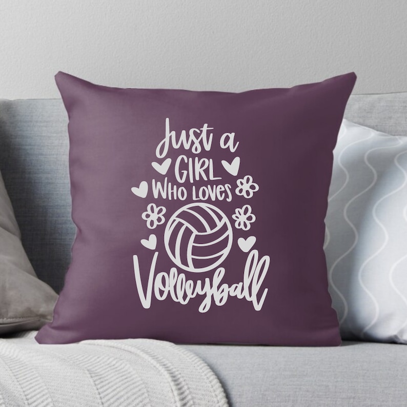 May include: Purple throw pillow with white text that reads "Just a girl who loves volleyball" with a white volleyball graphic.