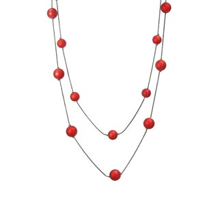 Red beaded multi row layered necklace designed with red matte finish beads attached to a dark gray hematite finish snake chain.