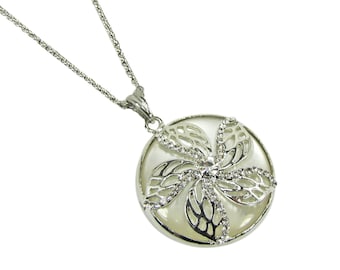 Flower round pendant created with crystals set into the flower on top of a white cat eye stone disk and set into a polished silver setting