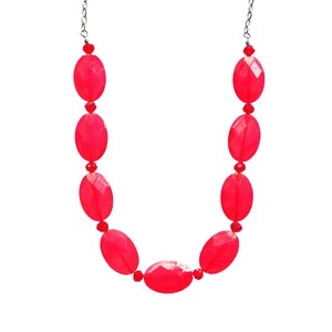 Beautiful red beaded necklace designed with oval flat acrylic beads and red glass beads.
