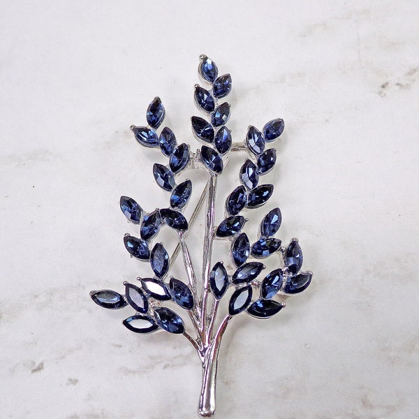 Blue sapphire color crystal tree pin brooch created with all blue marquise shape crystals set on a silver plated tree.