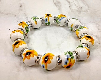 Yellow flowers with green leaves genuine porcelain bead and crystal stretch bracelet.  Porcelain beaded stretch bracelet with yellow flowers