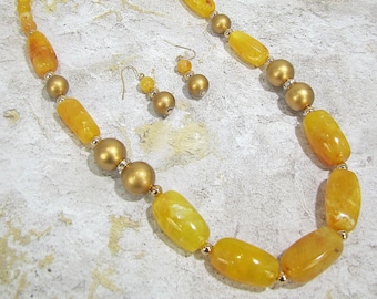 Yellow and gold bead necklace and earring set with crystals and designed with yellow marble look finish in long organic shape acrylic beads