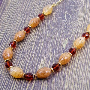 Beige citrene quartz stone necklace with brown glass beads and gold spacer beads.
