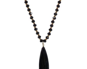 Beautiful long black glass and gold bead necklace with a black teardrop agate stone pendant.