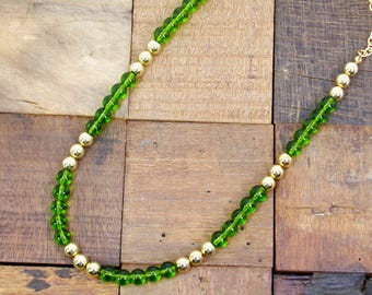 Colorful green and gold bead necklace designed with green round glass beads and round gold plated beads.