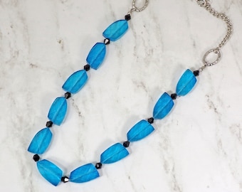Blue all glass beaded necklace designed with teal color blue glass beads mixed with small black glass beads.
