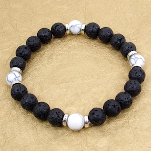 Black lava stone and white agate stone bead stretch bracelet designed with 8 mm beads and mixed with silver spacer beads.