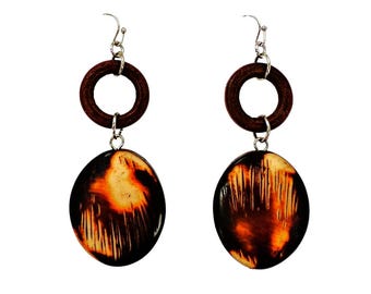 Brown earrings designed with a round wood disk and large oval acrylic wood looking bead.