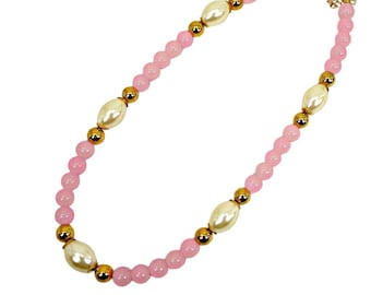 Pink glass and white pearl bead necklace designed with pink round glass beads, white acrylic beads, and polished gold beads.