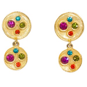 May include: Gold tone dangle earrings with two round discs. The top disc has five colorful gemstones, and the bottom disc has five colorful gemstones.
