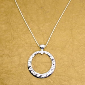 May include: A silver chain necklace with a textured, circular pendant.