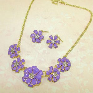 Purple Enamel and Crystal Fashion Flower Necklace and Earring Set. Flower necklace and earring set with purple enamel and clear crystals.