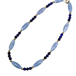 Blue bead necklace designed with a mix of light and blue beads and accented with small silver plated beads.