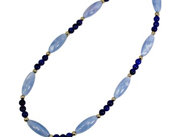 Blue bead necklace designed with a mix of light and blue beads and accented with small silver plated beads.