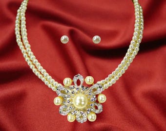 Pearl statement necklace set with large round pearl pendant, white faux pearls and crystals set onto a double row of white glass pearls
