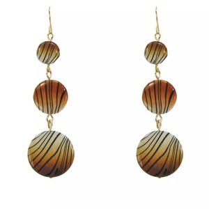 May include: A pair of gold dangle earrings with three round, brown and white striped beads.