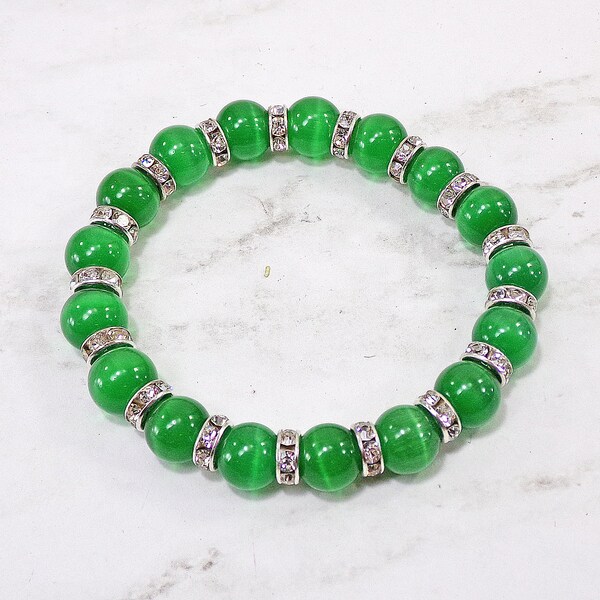 Green cat eye stretch bracelet made with cat eye stone beads and clear crystal spacer beads.  Beautiful green fashion bracelet.