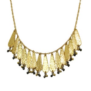 Gold fringe necklace designed with shiny gold metal dangling pieces with small beads attached to a gold plated chain.