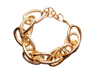 Gold link bracelet designed with shiny polished gold links and gold textured links  7.5 inches