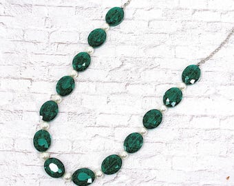 Green glass and white pearl bead necklace designed with large oval facet cut green glass beads. Green beaded fashion statement necklace