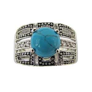 Turquoise round stone statement ring created with clear Cubic Zirconia stones on the sides in a wide band setting.