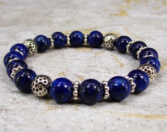 Blue sodalite stone stretch bracelet made with silver textured beads. Round polished stones, calming, balance, and self-assurance bracelet.