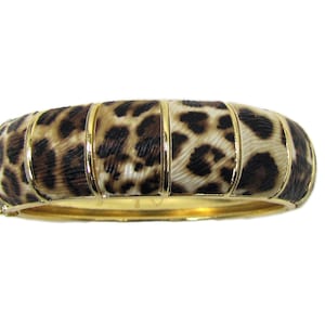 Animal print bangle bracelet with spring back hinge opening in gold finish. , Animal print fashion jewelry