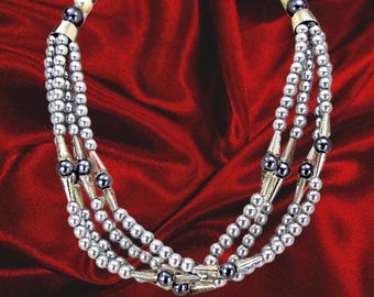 Gray pearl multi strand statement necklace with round gray acrylic pearls and gray black diamond glass beads. Created with 4 rows of beads