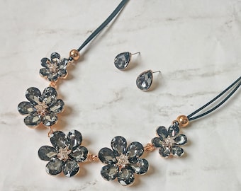 Elegant Black diamond gray color crystal flower statement necklace and earring set with flower stations linked together.